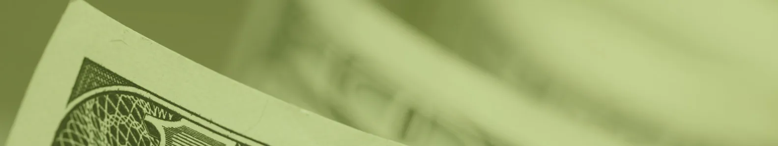 Business picture of part of a dollar bill on green background.