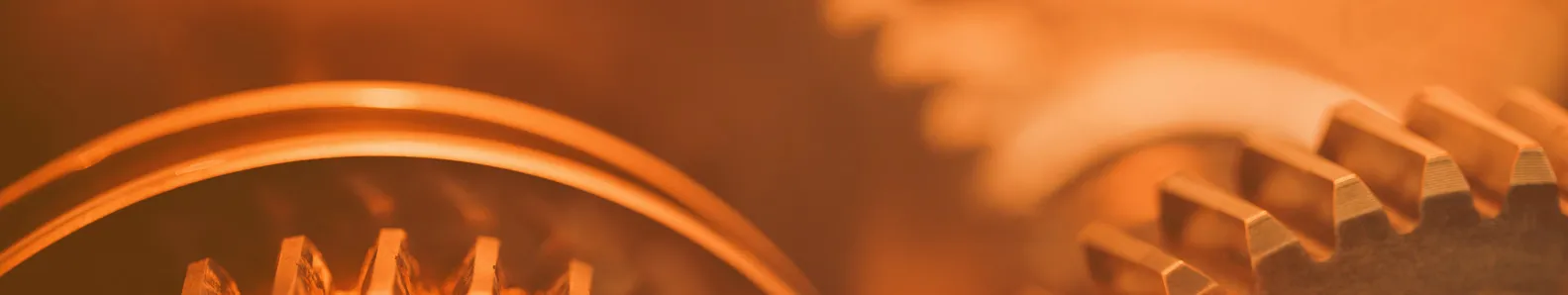 Engineering & Technology picture of orange gears in an orange background.